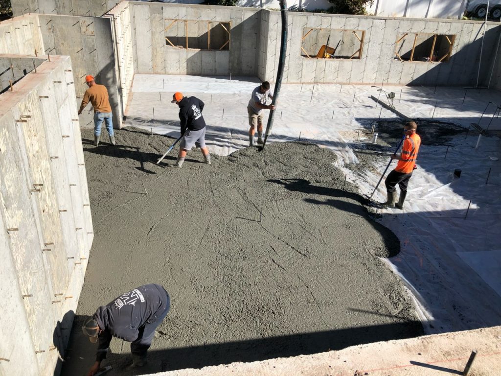 Crossbeam team leveling concrete for basement floor